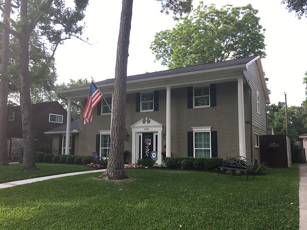 Two-story Houston home with a fresh roof and an American flag flying out front
