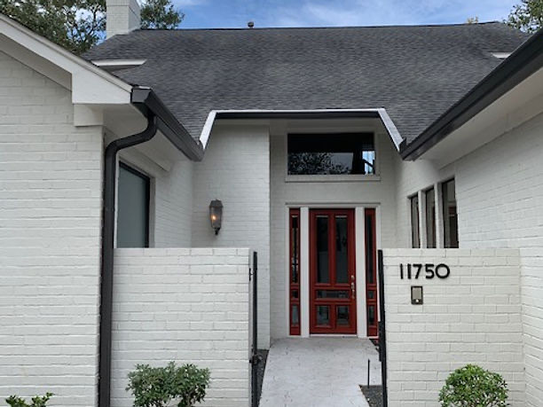 Fresh roof and clean lines on a modern white-brick Houston home