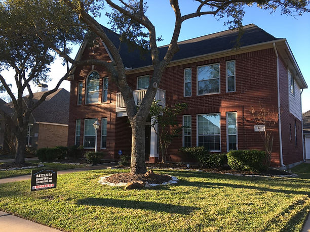 Completed roof on an upscale two-story brick home in Houston